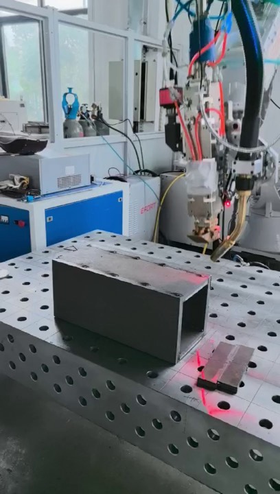 Real robotic laser welding workstation with robot, laser, and fixture table