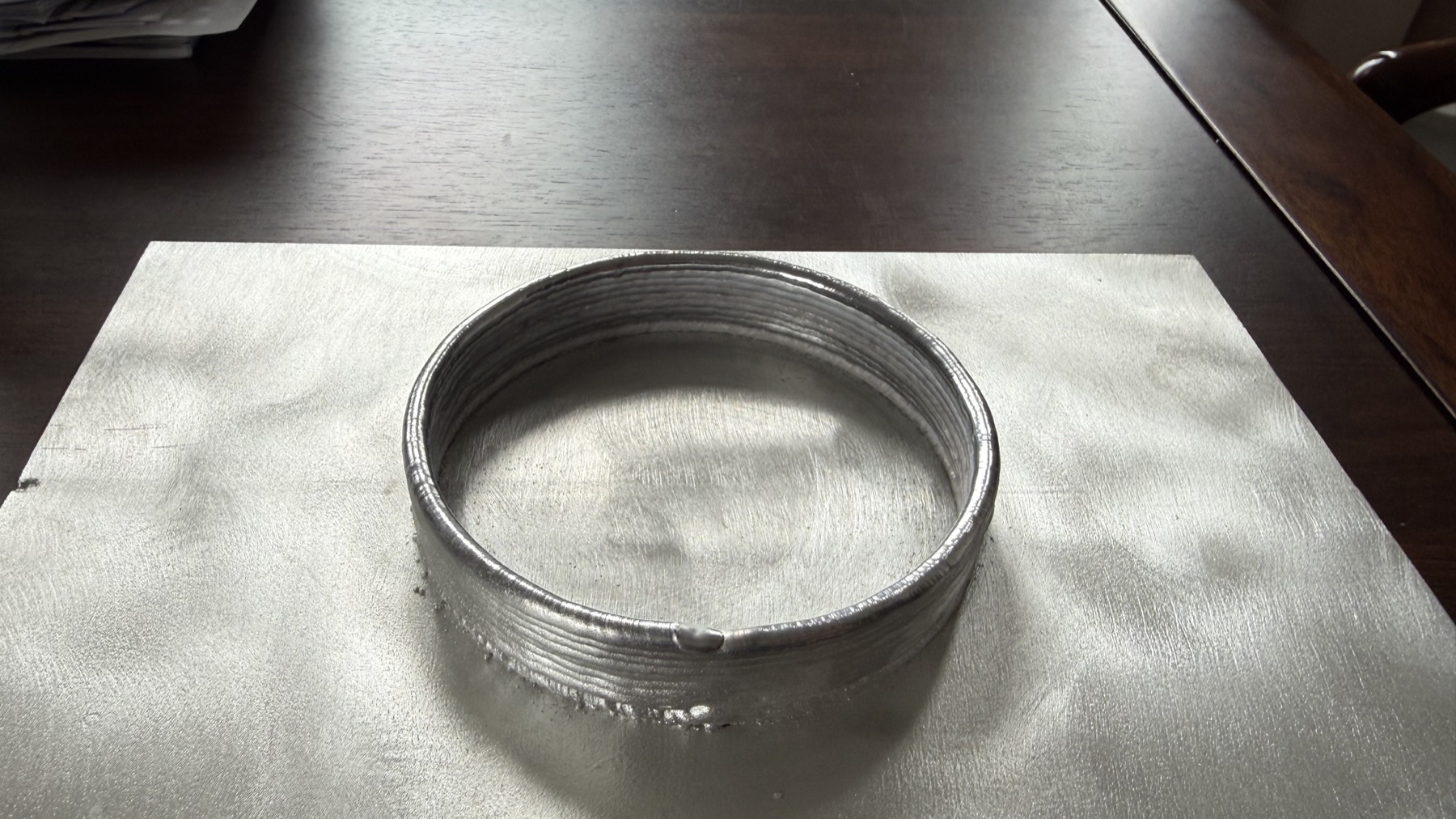 Circular robotic laser wire deposition training sample