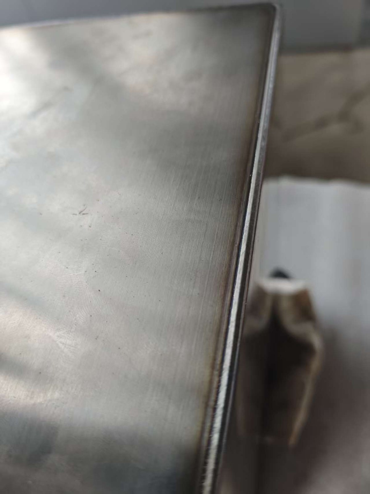 Second close-up weld seam detail on the welded metal enclosure sample